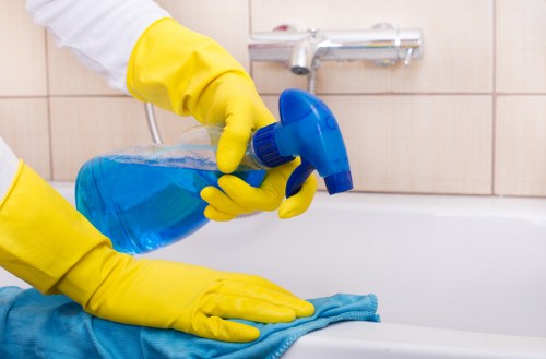 Cleaner maintaining stairwell and landing in a SE13 block of flats