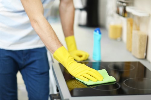 Cleaner working on skirting boards and floors in a SE13 rental property